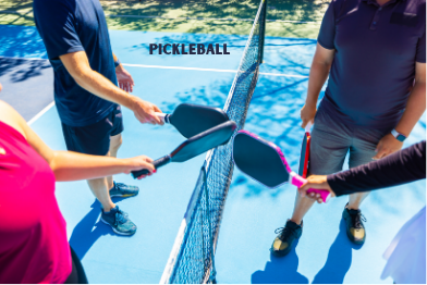 Pickleball Players holding multicolored paddles center court with word pickleball