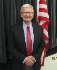 Picture of Mayor Siemborski dressed in dark suit, blue shirt and red tie
