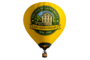  a yello hot air balloon withe a green circular logo with the Village of Gates Mills arching around a sawmill