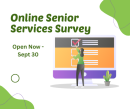 The back of a woman wearing a green shirt and purple pants in front of a large computer screen, appearing to take an online survey.