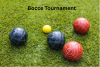 multi colored bocce balls on grass with written words bocce tournament